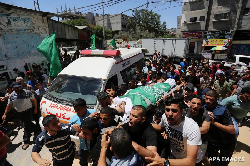 Mourners carry the body of 24-year-old Palestinian Mohammed al-Hamayda, who was killed by Israeli troops during clashes in tents protest where Palestinian demand the right to return to their homeland at the Israel-Gaza b...