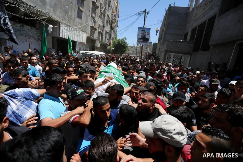 Mourners carry the body of 24-year-old Palestinian Mohammed al-Hamayda, who was killed by Israeli troops during clashes in tents protest where Palestinian demand the right to return to their homeland at the Israel-Gaza b...