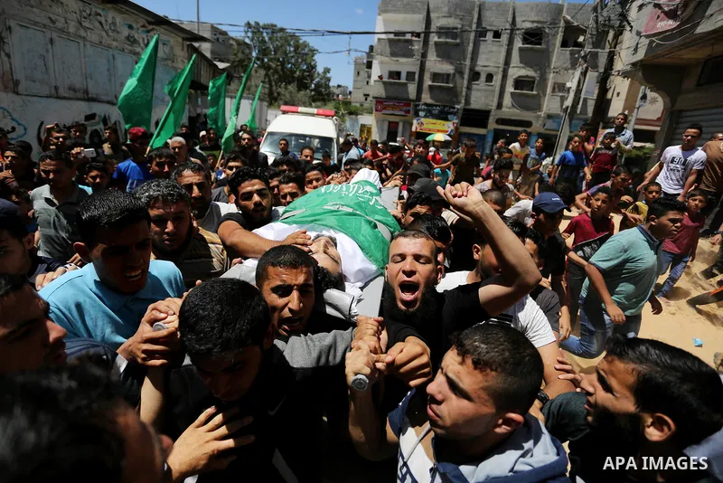 Mourners carry the body of 24-year-old Palestinian Mohammed al-Hamayda, who was killed by Israeli troops during clashes in tents protest where Palestinian demand the right to return to their homeland at the Israel-Gaza b...