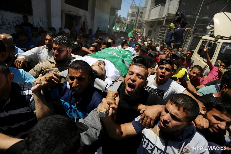 Mourners carry the body of 24-year-old Palestinian Mohammed al-Hamayda, who was killed by Israeli troops during clashes in tents protest where Palestinian demand the right to return to their homeland at the Israel-Gaza b...