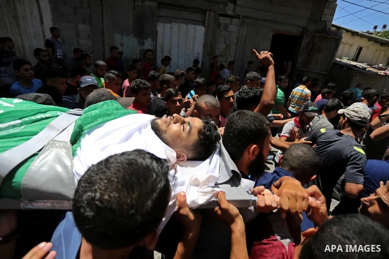 Mourners carry the body of 24-year-old Palestinian Mohammed al-Hamayda, who was killed by Israeli troops during clashes in tents protest where Palestinian demand the right to return to their homeland at the Israel-Gaza b...