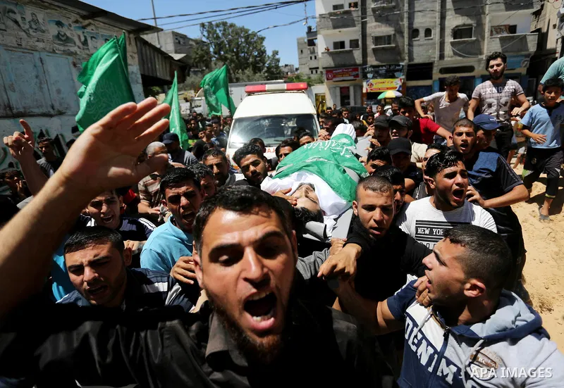 Mourners carry the body of 24-year-old Palestinian Mohammed al-Hamayda, who was killed by Israeli troops during clashes in tents protest where Palestinian demand the right to return to their homeland at the Israel-Gaza b...