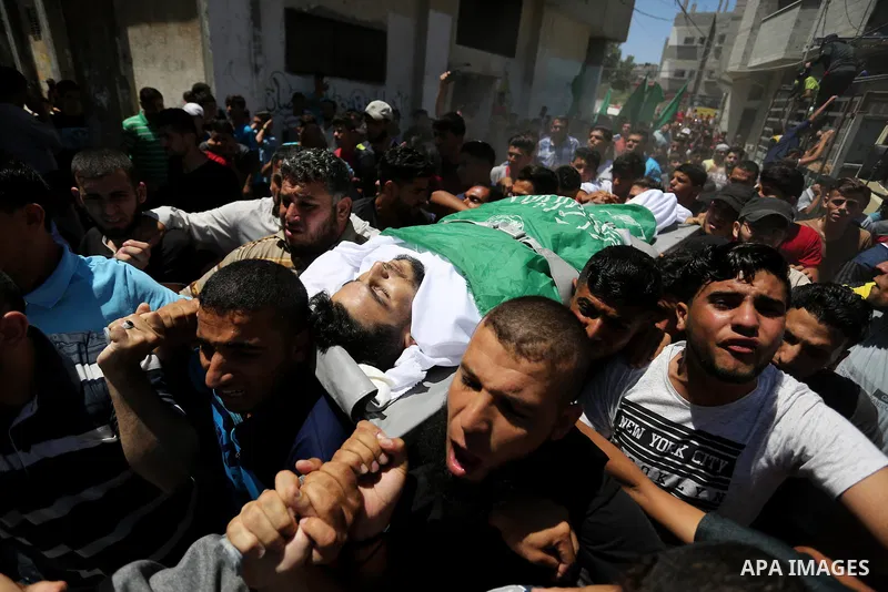 Mourners carry the body of 24-year-old Palestinian Mohammed al-Hamayda, who was killed by Israeli troops during clashes in tents protest where Palestinian demand the right to return to their homeland at the Israel-Gaza b...