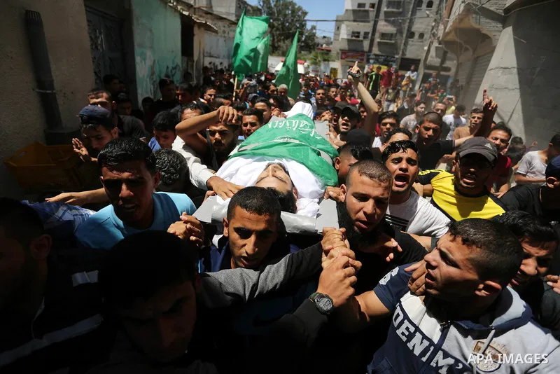 Mourners carry the body of 24-year-old Palestinian Mohammed al-Hamayda, who was killed by Israeli troops during clashes in tents protest where Palestinian demand the right to return to their homeland at the Israel-Gaza b...