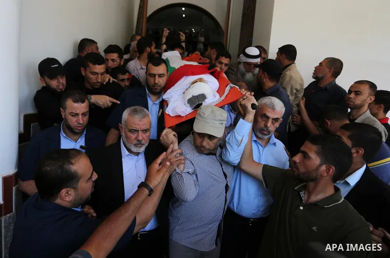 Mourners carry the body of 14-year-old Palestinian boy Yasser Abu Al-Naja, who was killed by Israeli troops during clashes in tents protest where Palestinian demand the right to return to their homeland at the Israel-Gaz...