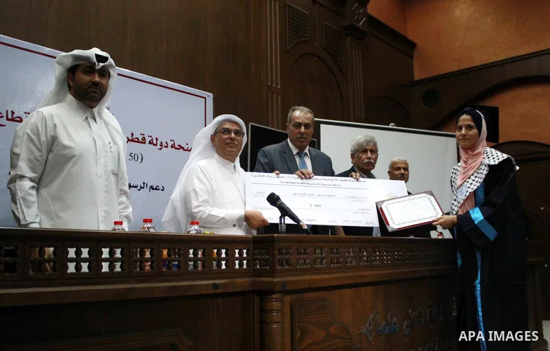 Qatar's Ambassador to the Palestinian Authority, Mohammed Al Emadi attends the ceremony of provide a grant to support the fees of Palestinian needy students at Al-Azhar University, in Gaza city on June 30, 2018. Photo by...