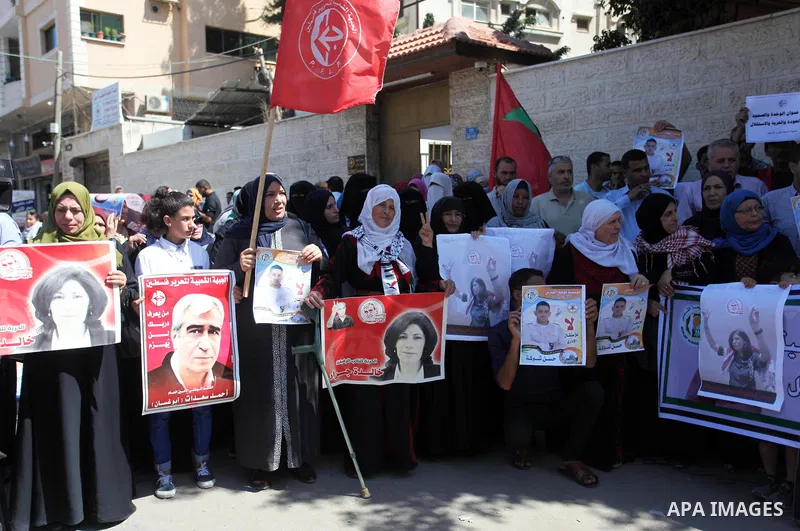 Palestinians take part a protest to show solidarity with the Leftist Legislator Khaleda Jarrar, in front of Red cross office in Gaza city on July 2, 2018. Photo by Mahmoud Ajour