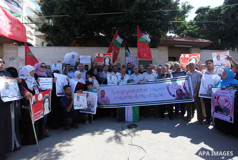 Palestinians take part a protest to show solidarity with the Leftist Legislator Khaleda Jarrar, in front of Red cross office in Gaza city on July 2, 2018. Photo by Mahmoud Ajour