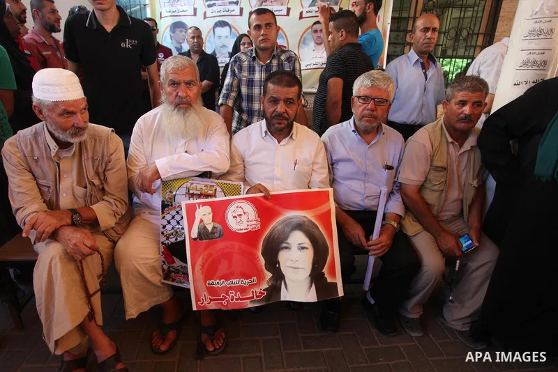Palestinians take part in a protest to show solidarity with Palestinian prisoners held in Israeli jails, in front of Red cross office in Gaza city on July 2, 2018. Photo by Mahmoud Ajour