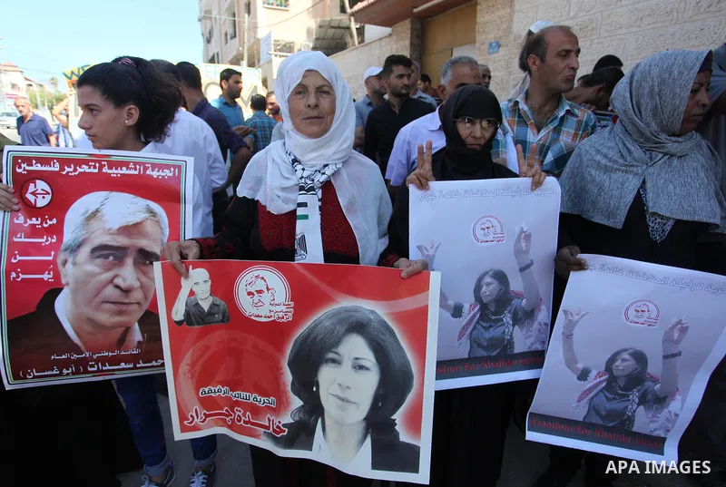 Palestinians take part a protest to show solidarity with the Leftist Legislator Khaleda Jarrar, in front of Red cross office in Gaza city on July 2, 2018. Photo by Mahmoud Ajour