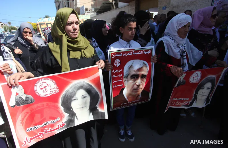 Palestinians take part a protest to show solidarity with the Leftist Legislator Khaleda Jarrar, in front of Red cross office in Gaza city on July 2, 2018. Photo by Mahmoud Ajour