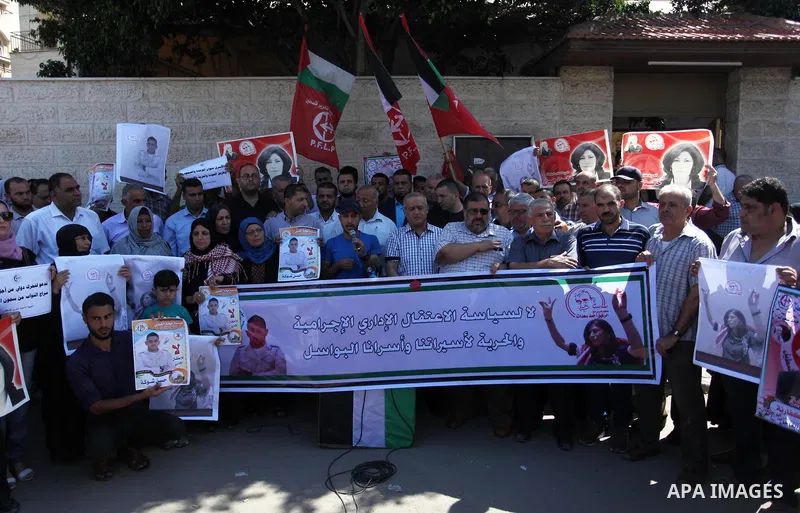 Palestinians take part a protest to show solidarity with the Leftist Legislator Khaleda Jarrar, in front of Red cross office in Gaza city on July 2, 2018. Photo by Mahmoud Ajour