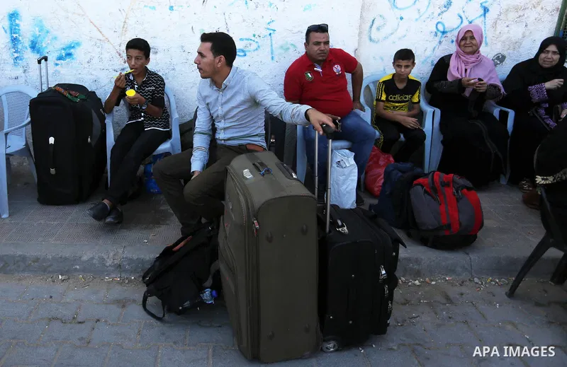 Palestinians wait for travel permits to cross into Egypt through the Rafah border crossing in Khan Yunis in the southern Gaza Strip on July 2, 2018. Photo by Ashraf Amra