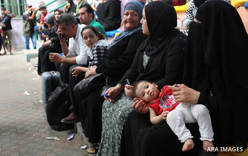 Palestinians wait for travel permits to cross into Egypt through the Rafah border crossing in Khan Yunis in the southern Gaza Strip on July 2, 2018. Photo by Ashraf Amra