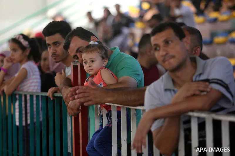 Palestinians wait for travel permits to cross into Egypt through the Rafah border crossing in Khan Yunis in the southern Gaza Strip on July 2, 2018. Photo by Ashraf Amra