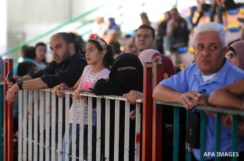 Palestinians wait for travel permits to cross into Egypt through the Rafah border crossing in Khan Yunis in the southern Gaza Strip on July 2, 2018. Photo by Ashraf Amra