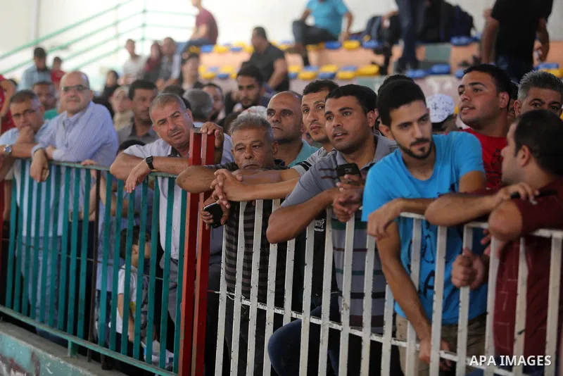 Palestinians wait for travel permits to cross into Egypt through the Rafah border crossing in Khan Yunis in the southern Gaza Strip on July 2, 2018. Photo by Ashraf Amra