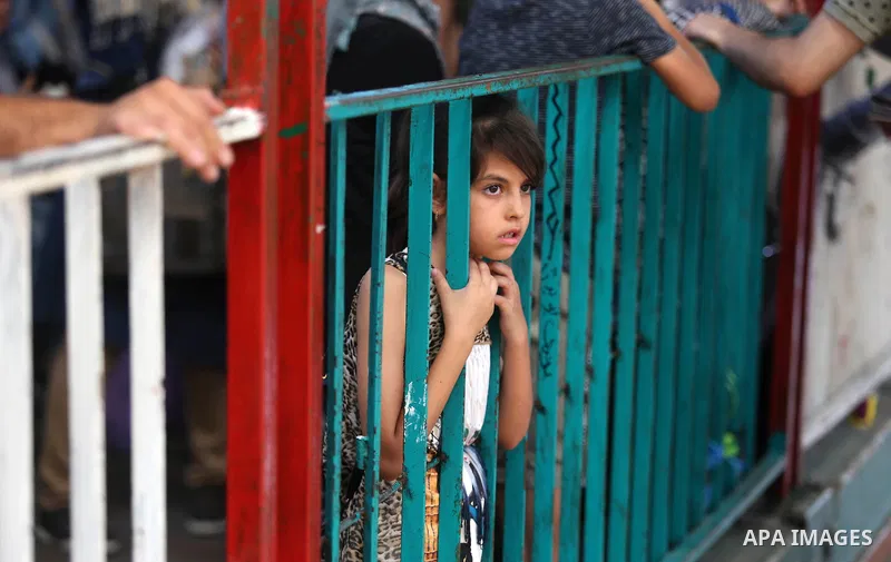 Palestinians wait for travel permits to cross into Egypt through the Rafah border crossing in Khan Yunis in the southern Gaza Strip on July 2, 2018. Photo by Ashraf Amra
