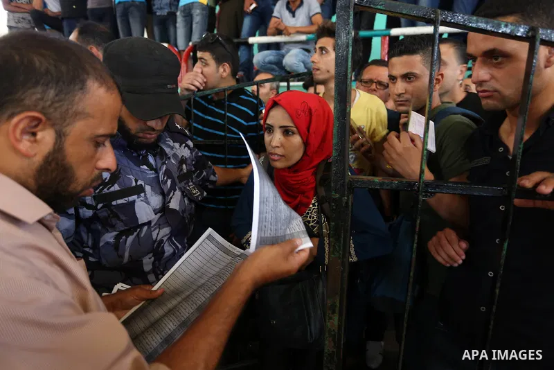 Palestinians wait for travel permits to cross into Egypt through the Rafah border crossing in Khan Yunis in the southern Gaza Strip on July 2, 2018. Photo by Ashraf Amra