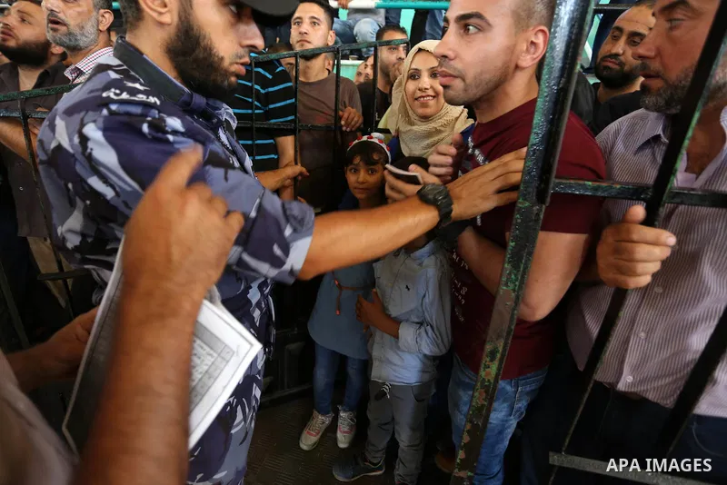 Palestinians wait for travel permits to cross into Egypt through the Rafah border crossing in Khan Yunis in the southern Gaza Strip on July 2, 2018. Photo by Ashraf Amra