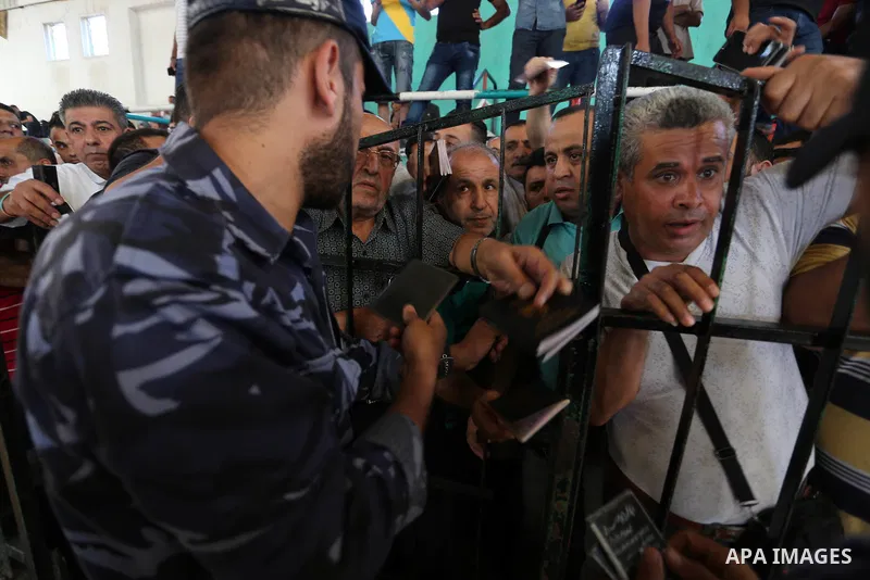 Palestinians wait for travel permits to cross into Egypt through the Rafah border crossing in Khan Yunis in the southern Gaza Strip on July 2, 2018. Photo by Ashraf Amra