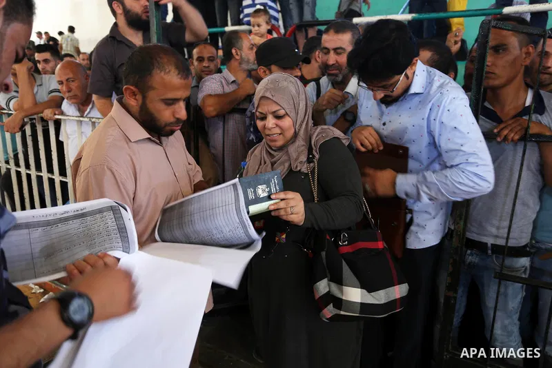 Palestinians wait for travel permits to cross into Egypt through the Rafah border crossing in Khan Yunis in the southern Gaza Strip on July 2, 2018. Photo by Ashraf Amra