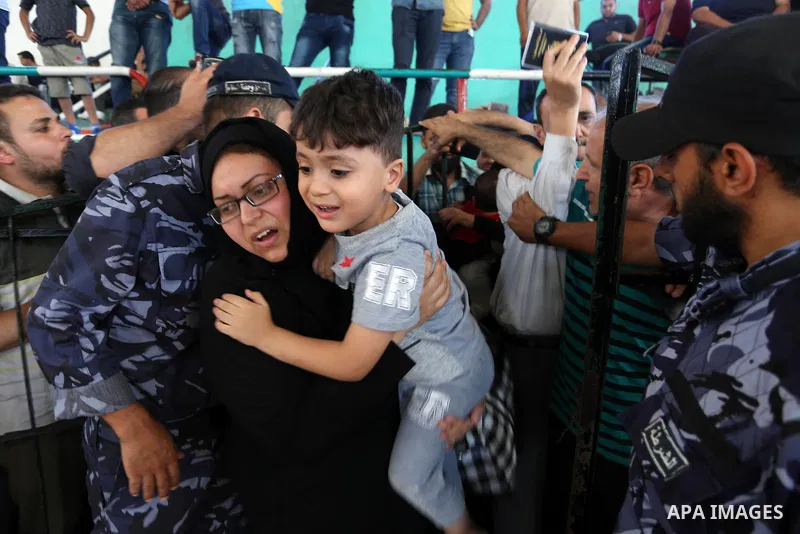 Palestinians wait for travel permits to cross into Egypt through the Rafah border crossing in Khan Yunis in the southern Gaza Strip on July 2, 2018. Photo by Ashraf Amra