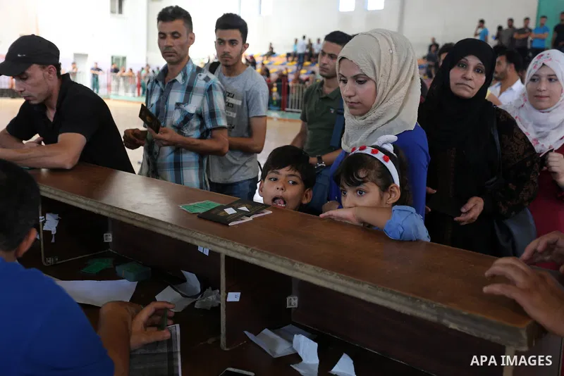 Palestinians wait for travel permits to cross into Egypt through the Rafah border crossing in Khan Yunis in the southern Gaza Strip on July 2, 2018. Photo by Ashraf Amra
