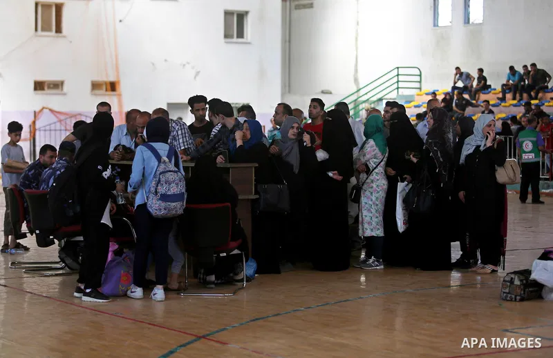 Palestinians wait for travel permits to cross into Egypt through the Rafah border crossing in Khan Yunis in the southern Gaza Strip on July 2, 2018. Photo by Ashraf Amra