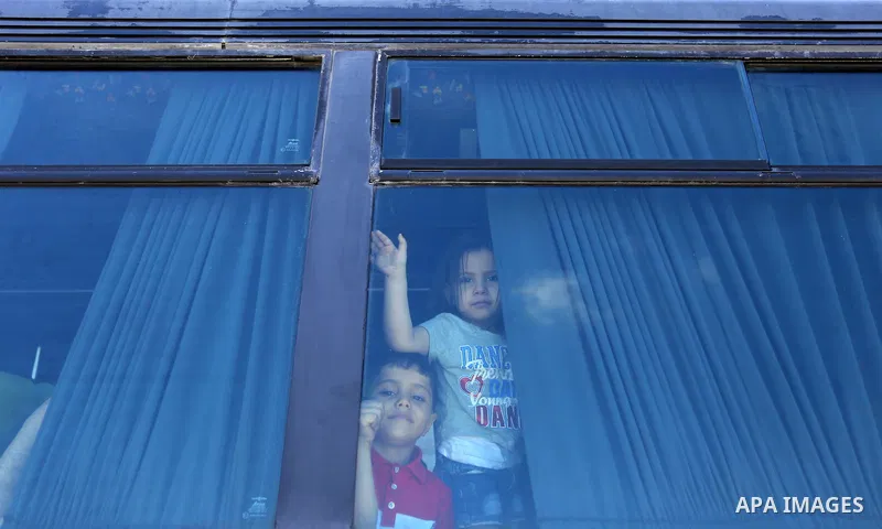 Palestinians wait for travel permits to cross into Egypt through the Rafah border crossing in Khan Yunis in the southern Gaza Strip on July 2, 2018. Photo by Ashraf Amra