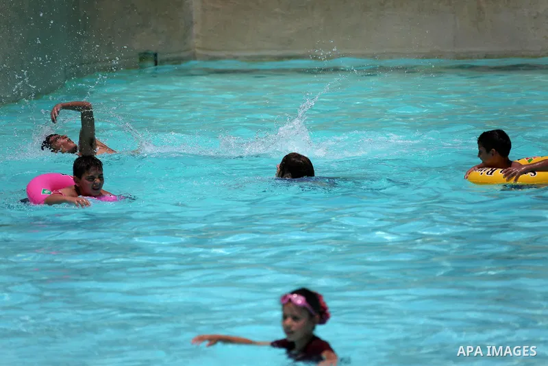 Palestinians swim in the water city "Safari Aqua Park" during the summer holiday, in the West Bank city of Jericho, on July 2, 2018. Photo by Shadi Hatem