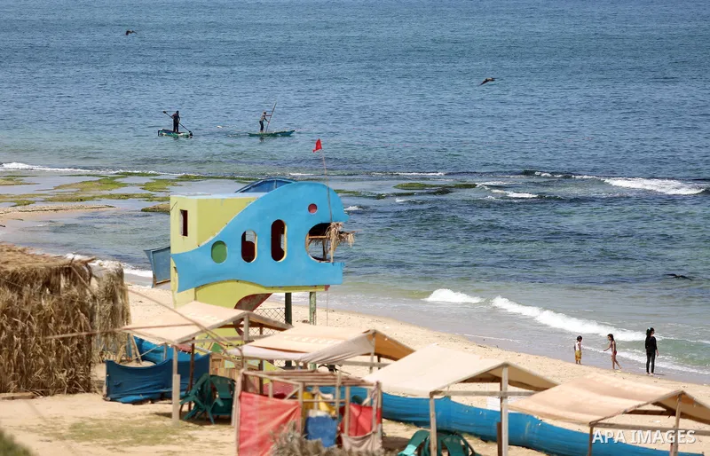 Palestinians enjoy thier time on the coast of Deir al-Balah's sea, in the center of Gaza Strip on July 3, 2018. Photo by Atia Darwish