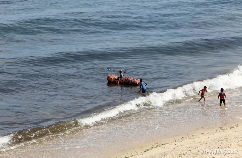 Palestinians enjoy thier time on the coast of Deir al-Balah's sea, in the center of Gaza Strip on July 3, 2018. Photo by Atia Darwish