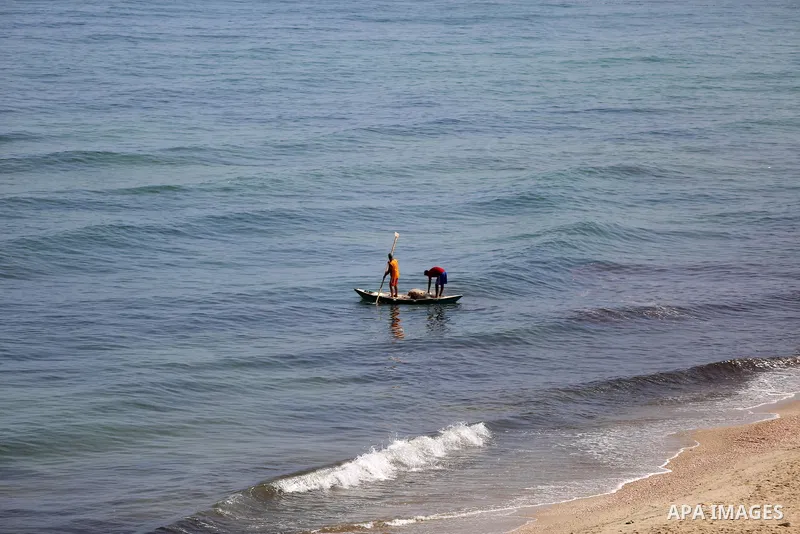 Palestinian fishermen ride their boat in the Mediterranean sea on the coast of Deir al-Balah, in the center of Gaza Strip on July 3, 2018. Photo by Atia Darwish