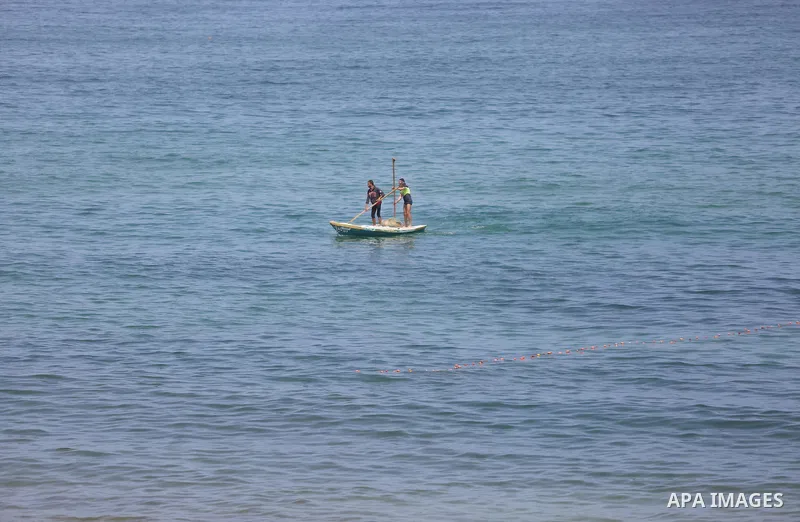 Palestinian fishermen ride their boat in the Mediterranean sea on the coast of Deir al-Balah, in the center of Gaza Strip on July 3, 2018. Photo by Atia Darwish
