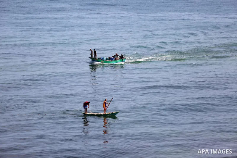 Palestinian fishermen ride their boat in the Mediterranean sea on the coast of Deir al-Balah, in the center of Gaza Strip on July 3, 2018. Photo by Atia Darwish