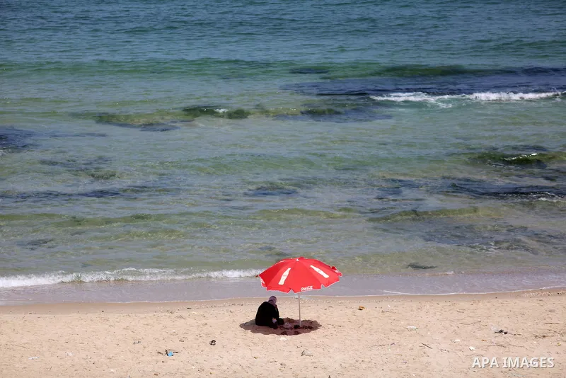 Palestinians enjoy thier time on the coast of Deir al-Balah's sea, in the center of Gaza Strip on July 3, 2018. Photo by Atia Darwish