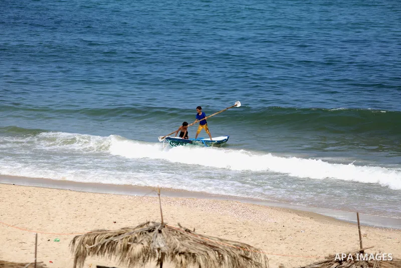 Palestinian fishermen ride their boat in the Mediterranean sea on the coast of Deir al-Balah, in the center of Gaza Strip on July 3, 2018. Photo by Atia Darwish