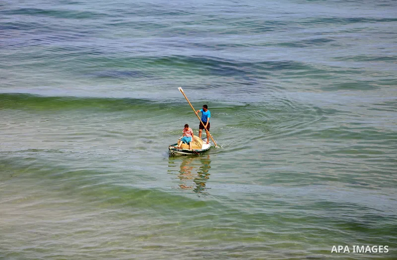 Palestinian fishermen ride their boat in the Mediterranean sea on the coast of Deir al-Balah, in the center of Gaza Strip on July 3, 2018. Photo by Atia Darwish