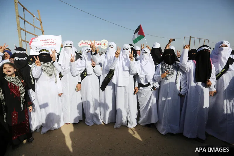 Palestinian women gather during a protest where Palestinians demand the right to return to their homeland along the border with Israel east of Gaza City on July 3, 2018. Photo by Ashraf Amra