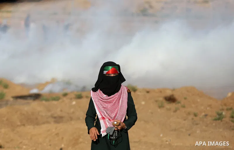 Palestinian women gather during a protest where Palestinians demand the right to return to their homeland along the border with Israel east of Gaza City on July 3, 2018. Photo by Ashraf Amra