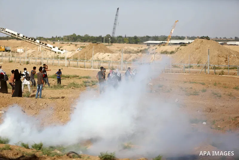 Palestinian women gather during a protest where Palestinians demand the right to return to their homeland along the border with Israel east of Gaza City on July 3, 2018. Photo by Ashraf Amra