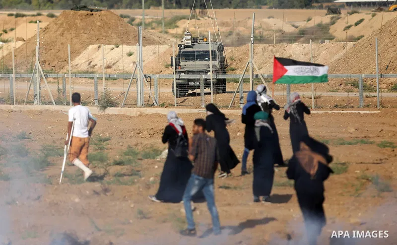 Palestinian women gather during a protest where Palestinians demand the right to return to their homeland along the border with Israel east of Gaza City on July 3, 2018. Photo by Ashraf Amra