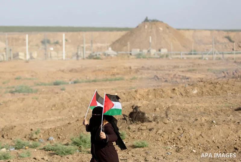 Palestinian women gather during a protest where Palestinians demand the right to return to their homeland along the border with Israel east of Gaza City on July 3, 2018. Photo by Ashraf Amra