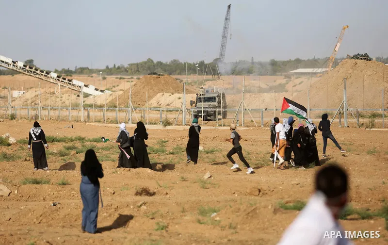 Palestinian women gather during a protest where Palestinians demand the right to return to their homeland along the border with Israel east of Gaza City on July 3, 2018. Photo by Ashraf Amra