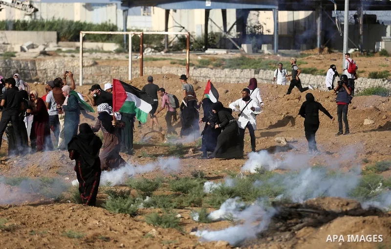 Palestinian women gather during a protest where Palestinians demand the right to return to their homeland along the border with Israel east of Gaza City on July 3, 2018. Photo by Ashraf Amra