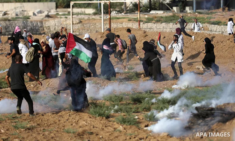 Palestinian women gather during a protest where Palestinians demand the right to return to their homeland along the border with Israel east of Gaza City on July 3, 2018. Photo by Ashraf Amra