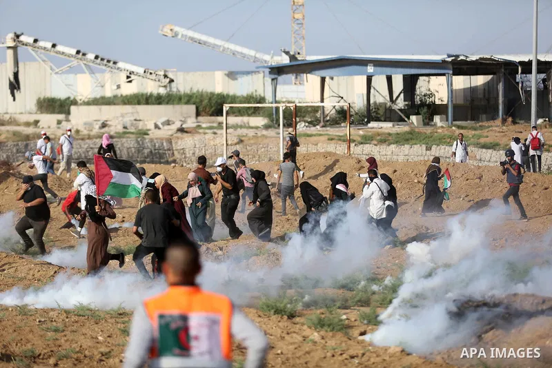 Palestinian women gather during a protest where Palestinians demand the right to return to their homeland along the border with Israel east of Gaza City on July 3, 2018. Photo by Ashraf Amra