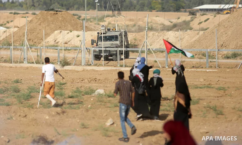 Palestinian women gather during a protest where Palestinians demand the right to return to their homeland along the border with Israel east of Gaza City on July 3, 2018. Photo by Ashraf Amra