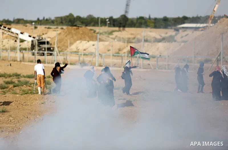 Palestinian women gather during a protest where Palestinians demand the right to return to their homeland along the border with Israel east of Gaza City on July 3, 2018. Photo by Ashraf Amra